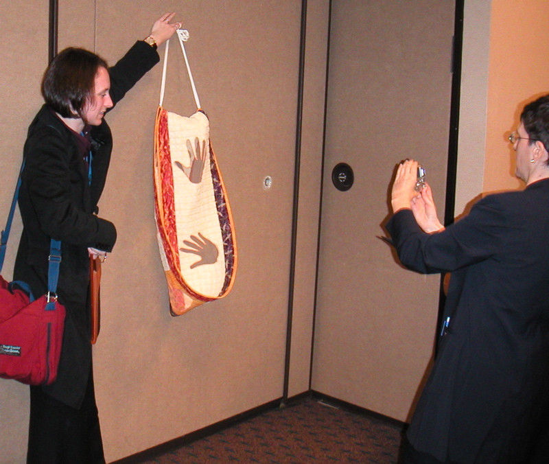 Amy Szczepanski (who hates having her picture taken) allows her first Mobius quilt to be photographed by someone at the AMS