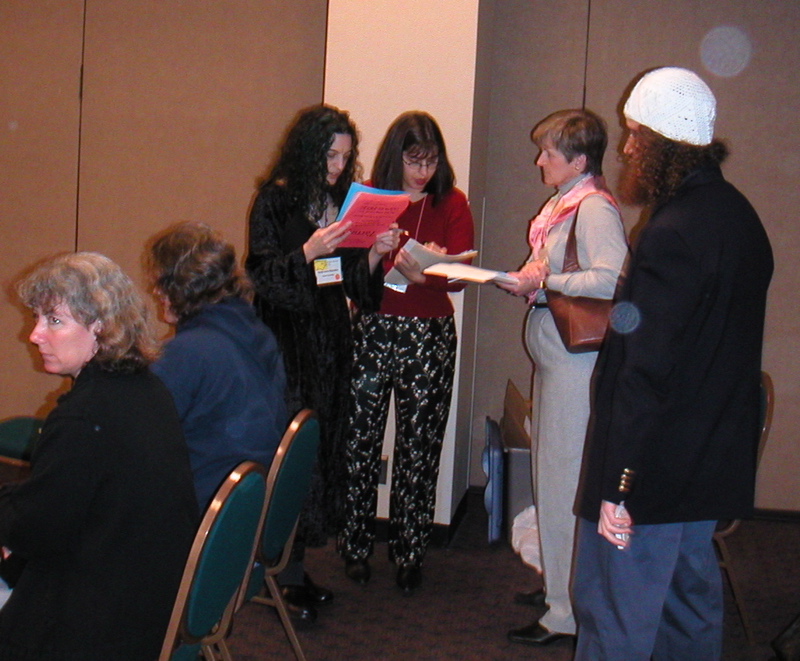 In the back of the Special Session room, sm and Carolyn try to schedule a meeting with Vickie Kearn of PUP.