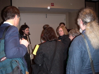 more people at the exhibit, including Neil Epstein on the left, Daina Taimina in the middle, and Walter Carlip's hair on the right.