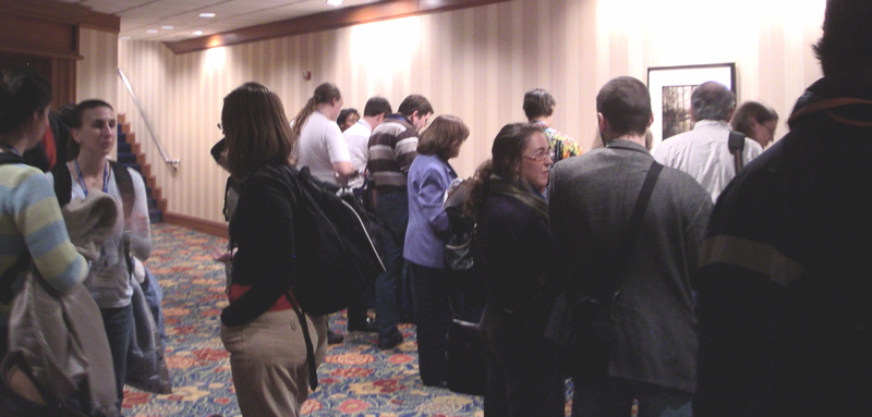 More clumps of exhibit-goers having conversations